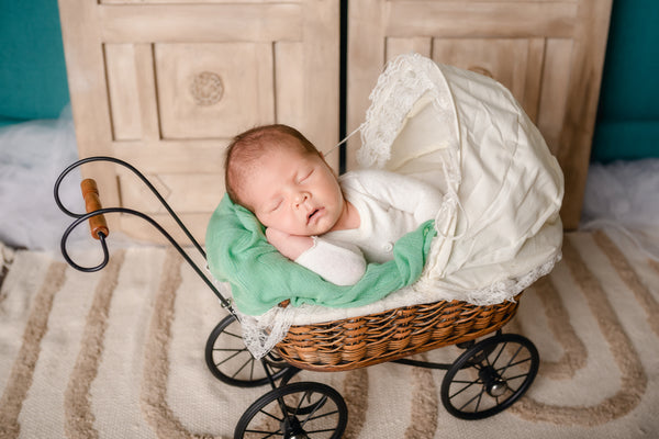 sleeping baby in old stroller