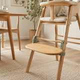 Natural bamboo adjustable footrest attached to a wooden high chair
