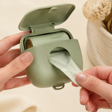 Adult hands loading a refill roll into the sage dispenser