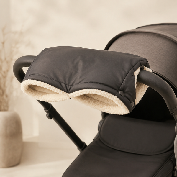 Charcoal fleece-lined hand muff attached to a stroller handlebar
