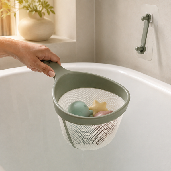 Adult hand scooping pastel bath toys from an empty bathtub