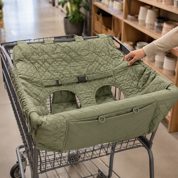 Sage leaf padded seat cover installed in an empty shopping cart