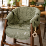 Washable sage leaf cover installed on an empty restaurant high chair