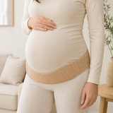 Pregnant adult wearing the support band low under the belly over clothing