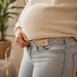 Beige maternity waist extender adding room to a jeans waistband