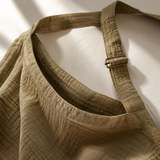 Close-up of muslin nursing cover neckline strap and breathable weave