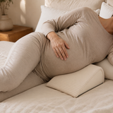Pregnant adult side sleeping with the compact wedge positioned under the belly