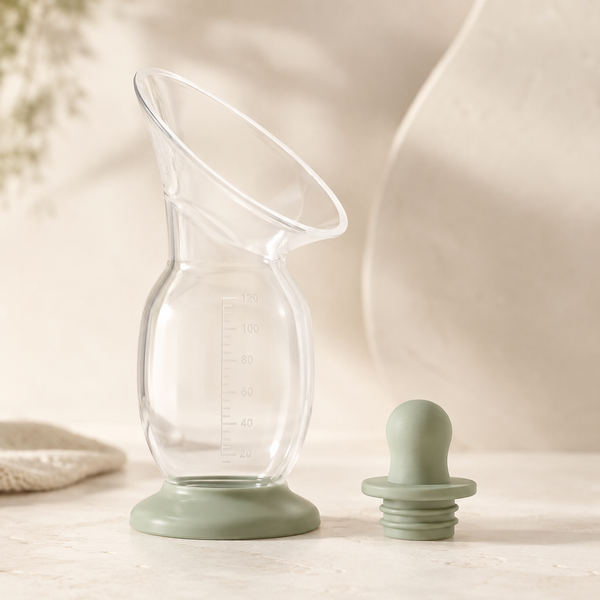Clear silicone breast milk collector with sage stopper and stable base