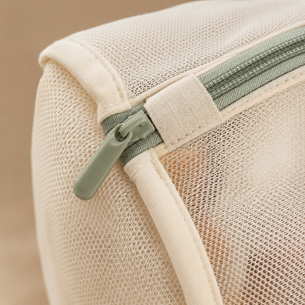 Close-up of fine mesh, reinforced seam and sage zipper guard
