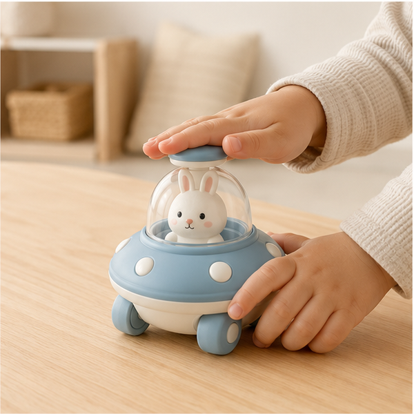 Child pressing a battery-free animal UFO toy car