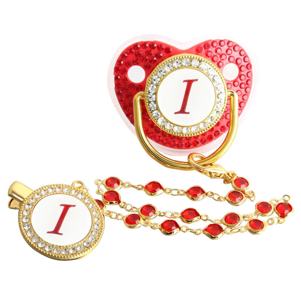 Red and gold initial I pacifier with matching decorative clip