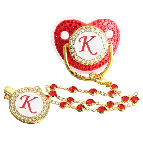Red and gold initial K pacifier with matching decorative clip