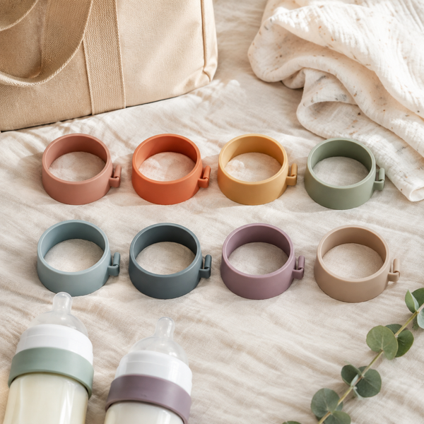 Eight muted color bottle identification bands arranged with feeding essentials