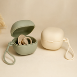 Sage and cream silicone pacifier storage cases with loop straps