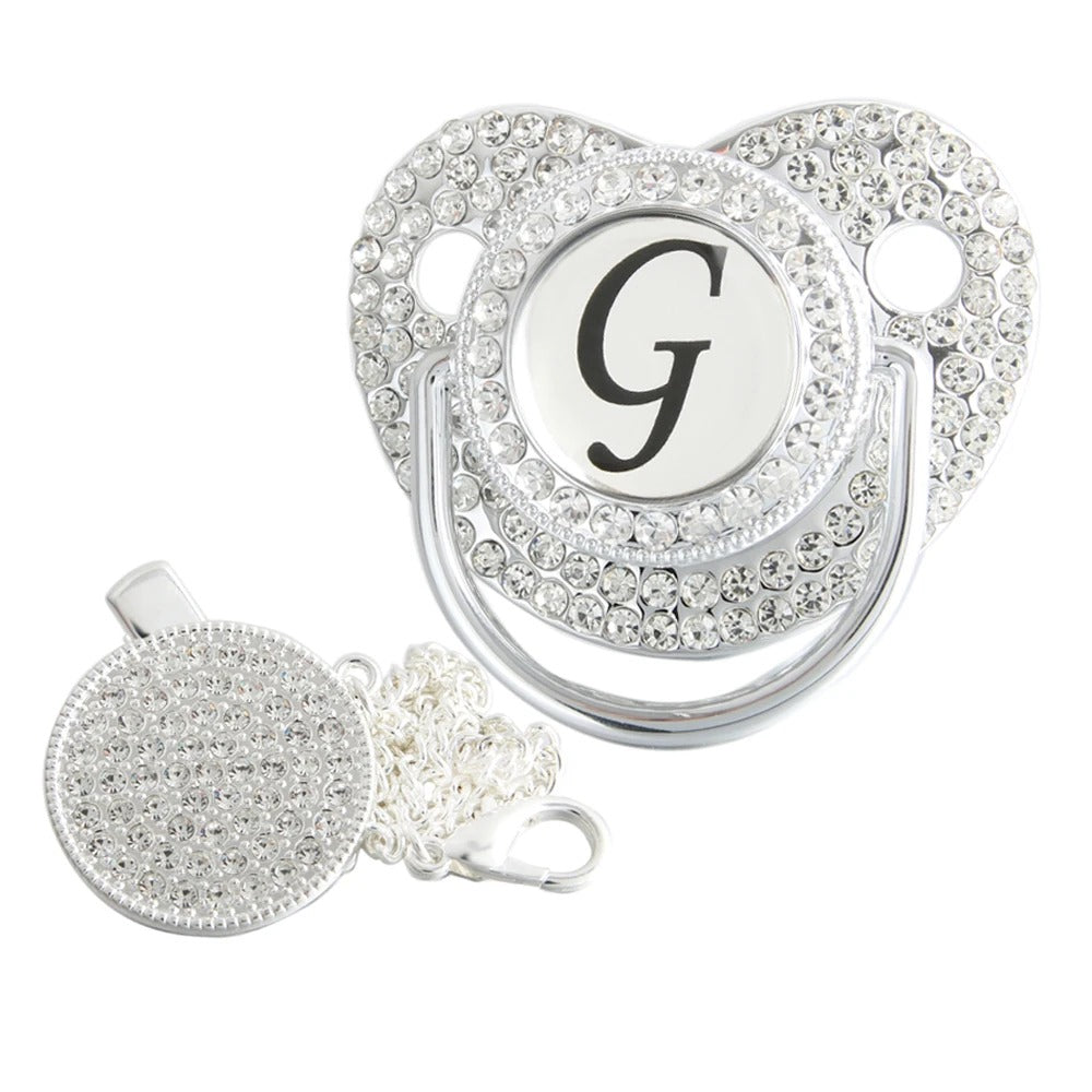 Silver initial G bling pacifier with matching round decorative clip