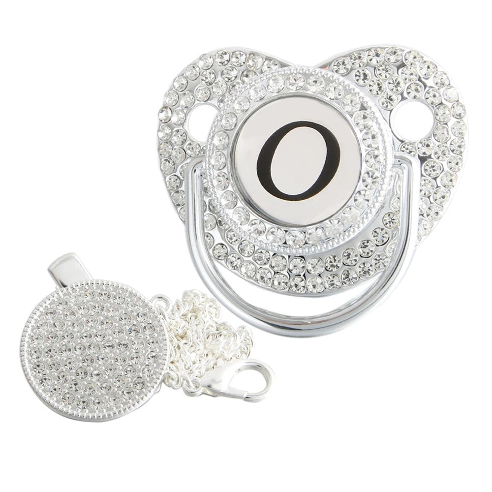 Silver initial O bling pacifier with matching round decorative clip