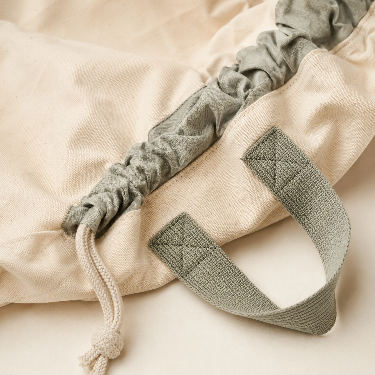 Close-up of canvas, gathered edge, drawstring and carry handle