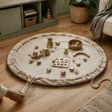 Circular oatmeal playmat with neutral toys in a calm playroom