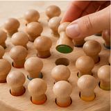 Close-up of a lifted wooden peg revealing its color